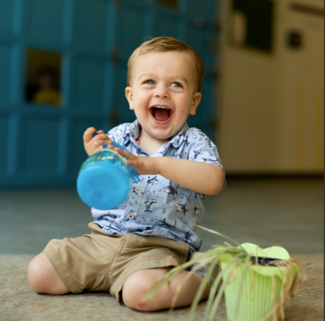Boy with plant and spray bottle